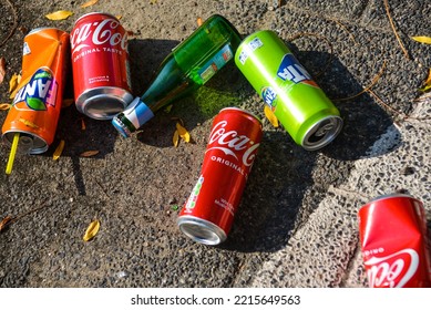 The Hague, The Netherlands - September 11 2022: Colorful Empty Drink Cans On Street, Tea Paper Cup, Beer Bottle And Softdrink Tin Cans Thrown As Litter On Street In Dutch City Centre, Fanta, Coca Cola