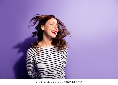 Ha-ha! Portrait with copy space empty place of cheerful laughter funny comic girl having flying hair isolated on violent background, enjoying wind flow