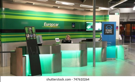 HAHN, GERMANY - DECEMBER 7, 2016: Europcar car rental employee waits for customers at Frankfurt Hahn Airport in Germany. Europcar has a fleet of 200,000 vehicles in 140 countries.
