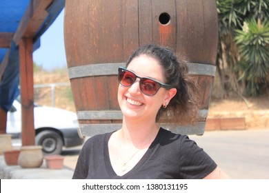 Haifa, Israel - August 23 2016:An Israeli Women In Her 20s Stands Outside Her Workplace With A Smile On Her Face! 