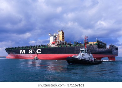 Haifa, Israel - February 2, 2016: MSC Mega Container Ship Pulled By A Tag Boat Into Haifa's Commercial Port.