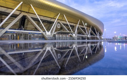 HAIFA, ISRAEL -JAN 7, 2021: Sammy Ofer Stadium Reflected In A Winter Puddle, Exterior Night View Of The New Sami Ofer Soccer Stadium, New Home Base Of Maccabi Haifa Fc Football Club. 