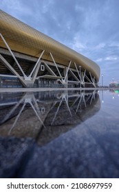 HAIFA, ISRAEL -JAN 7, 2021: Sammy Ofer Stadium Reflected In A Winter Puddle, Exterior Night View Of The New Sami Ofer Soccer Stadium, New Home Base Of Maccabi Haifa Fc Football Club. 