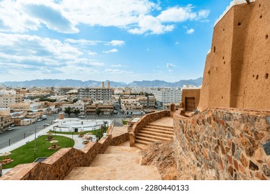 Hail city downtown and walls of Arabian Aarif fortress standing on the hill, Hail, Saudi Arabia