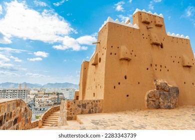 Hail city downtown and walls of Arabian Aarif fortress standing on the hill, Hail, Saudi Arabia
