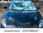 hail damage to car. damaged hood and windshield