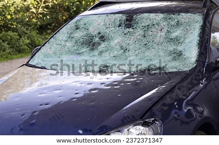 Hail damage to a car. Large hailstones have completely destroyed a car