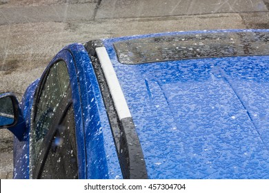 Hail Falls On A Blue Car Roof.