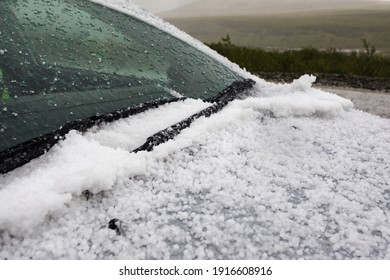 A Lot Of Hail On The Hood And On The Windshield Of The Car