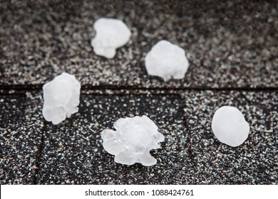 Hail in on roof after hailstorm, shallow focus on hail ball in front