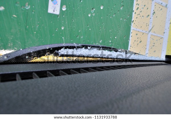 hail on the windshield of\
the car