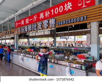 HAINAN, CHINA - 3 MAR 2019 - Stall Owners At A Seafood Wholesale And Retail Wet Market In Hainan, China