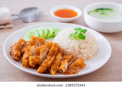 Hainanese chicken rice with fried chicken or oily rice with fried chicken and chili sauce