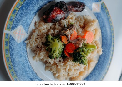 Hainanese Grilled Roasted Chicken Rice With Brocolli And Slice Of Carrot On A Plate. Asian Food Style