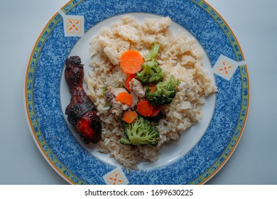 Hainanese Grilled Roasted Chicken Rice With Brocolli And Slice Of Carrot On A Plate. Asian Food Style