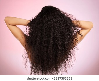 Hair, beauty and back of woman with hairstyle transformation and curly texture. Model, salon treatment and haircut shine in a studio with pink background and cosmetics with keratin and growth care