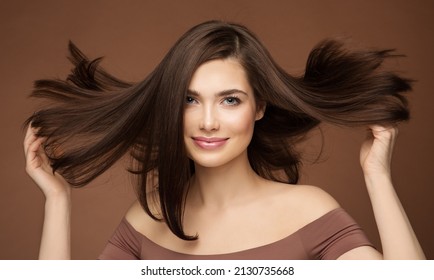 Hair Beauty Model. Brunette Woman with Straight Hairstyle flying on Wind over Dark Beige. Young Smiling Girl with Smooth Skin Make up - Shutterstock ID 2130735668