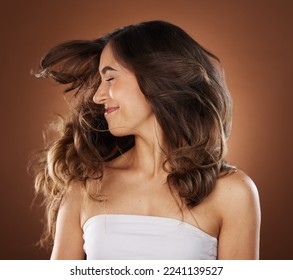 Hair, beauty and skincare with a model woman in studio on a brown background for natural or keratin treatment. Face, haircare and salon with an attractive young female posing to promote a product - Shutterstock ID 2241139527