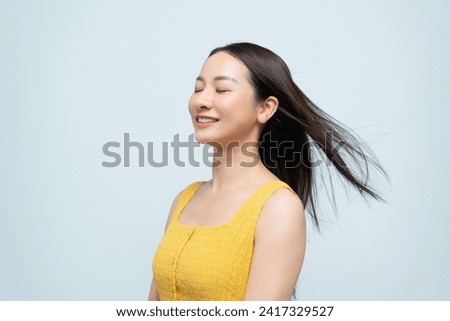 Hair blowing young woman over white background