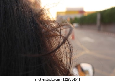 The Hair Is Blown Away With The Wind.