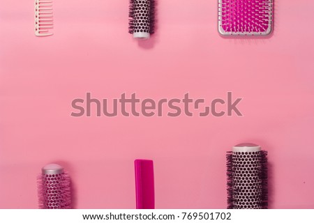 Hair brushes on the pink background. Top view