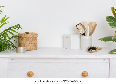 Hair brushing and make up items on wooden dressing table