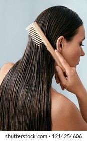 Hair Care. Beautiful Woman Brushing Wet Long Hair After Bath 