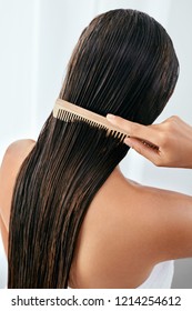 Hair Care. Beautiful Woman Brushing Wet Long Hair After Bath 