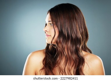 Hair care, beauty and woman in studio for cosmetic, makeup and growth or shine shampoo with keratin for health and wellness. Aesthetic model on blue background for skincare and luxury salon treatment - Shutterstock ID 2227982411