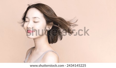 Hair care concept of young Asian woman. Beauty salon. Cosmetics.