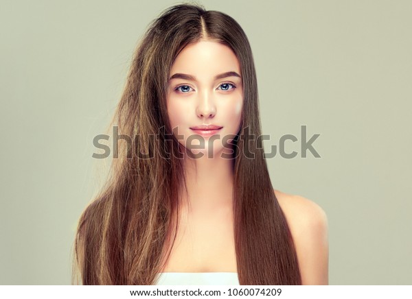 Hair care . Keratin straightening ,smoothing and\
treatment of the hair .  Girl with straight and smooth hair on one\
side of the head . The second side of the head tangled and un\
brushed hair . 
