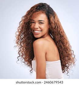 Hair care, smile and portrait of woman in studio for natural, health and salon treatment. Happy, beauty and female person from Mexico with curly hairstyle for clean hygiene routine by gray background - Powered by Shutterstock