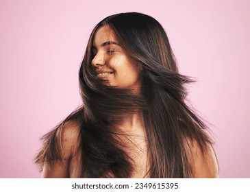 Hair care, smile and woman shaking head in studio, luxury salon treatment and shine with texture. Healthy haircare wellness, beauty aesthetic and cosmetics, happy girl with glow and pink background.