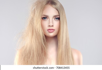 Hair care . Straightening ,smoothing and treatment of the hair .  Girl with straight and smooth hair on one side of the head . The second side of the head tangled and un brushed hair .