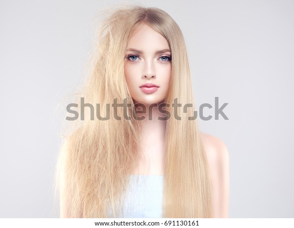 Hair care .\
Straightening ,smoothing and treatment of the hair .  Girl with\
straight and smooth hair on one side of the head . The second side\
of the head tangled and unbrushed hair\
.