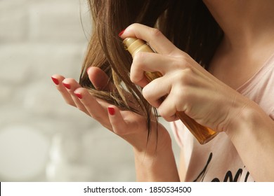 Hair Care. Woman Applying Oil On Hair Ends. Split Hair Tips, Dry Hair Or Sun Protection Concept.	