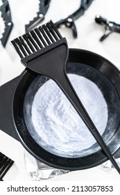 Hair Color Dye Powder In A Black Plastic Mixing Bowl On A White Background.