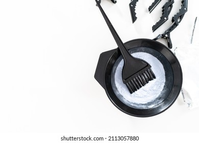 Hair Color Dye Powder In A Black Plastic Mixing Bowl On A White Background.