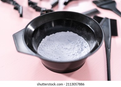 Hair Color Dye Powder In A Black Plastic Mixing Bowl On A Pink Background.