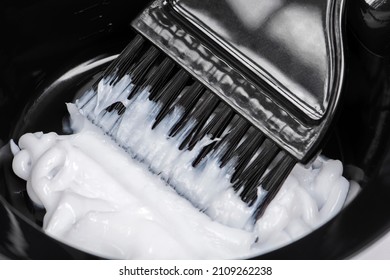 Hair coloring. Hair dye in a bowl with a brush - Shutterstock ID 2109262238