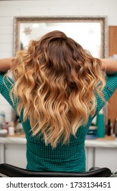 Hair coloring gradient from light golden to brown girl and long curly hair in the back