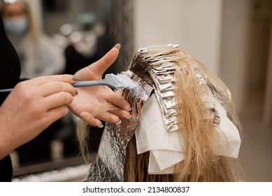 Hair coloring, regrown hair roots, on foil, blonde, hairdresser colorist, beauty salon - Powered by Shutterstock