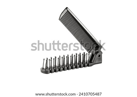 Hair Comb. Sisir lipat. Black double sided folded comb, made by plastic, for travelling, isolated on white background. Close up