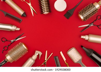 Hair Cutting Tools Arranged In A Circle On Red Background