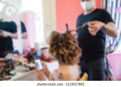 Hair Dresser, Blurred Background Of A Male Hair Dresser Or Stylist Making Or Doing Hair Of A Woman With Health Mask In Covid19 Pandemic. Hairdresser Salon Concept Photo Background