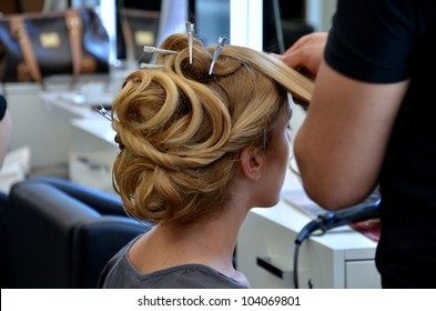 Hair Dresser Doing Hair Of A Blond Woman