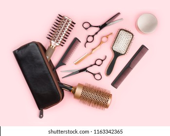 Hair Dresser Tool Set With Leather Bag On Pink Background