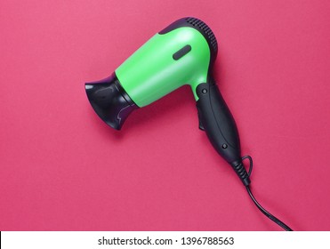 Hair Dryer On Red Background. Top View