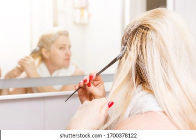 Hair Dyeing In The Domestic Bathroom. One Woman Only