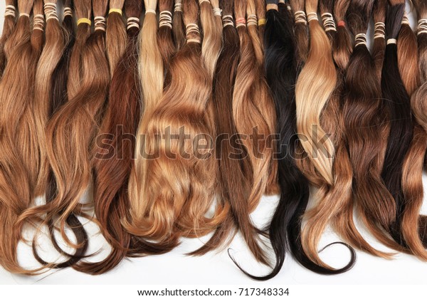 Hair extension equipment of natural hair. Hair\
samples of different\
colors